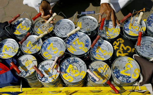 A dabbawalla sorts a crate of tiffin boxes