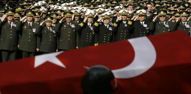 The flag-wrapped coffin of Lieutenant Gokhan Yavuz is saluted by army officers during a funeral ceremony