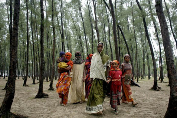 People travel to safe shelters while cyclone Sidr approaches the coast