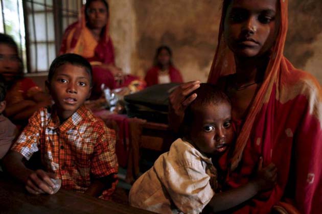 A Bangladeshi family gather for shelter