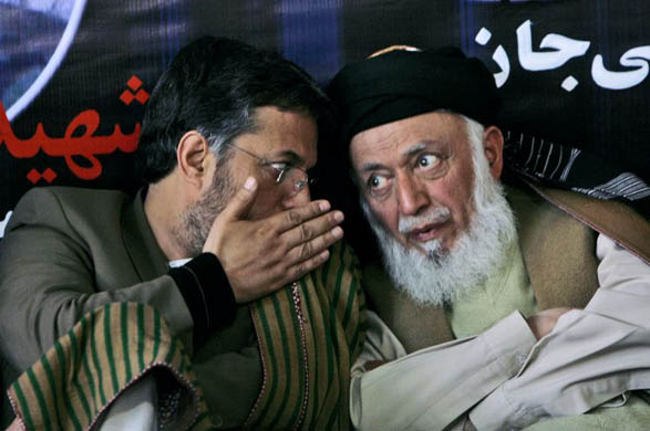 Head of parliament Mohammad Younus Qanooni, left, speaks to lawmaker and former president Burhanudin Rabani during a memorial ceremony for the six parliamentarians who were killed in a suicide attack in Baghlan province