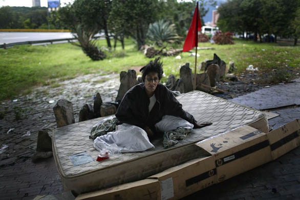 Antonela, 47, who has been a homeless since she was 14, sits in her shelter under a highway