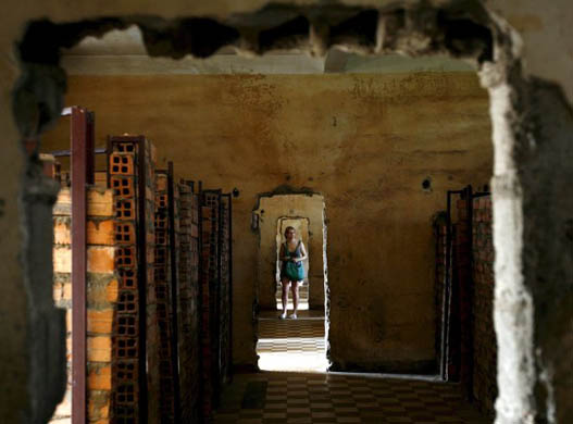 A tourist visits Tuol Sleng genocide museum where up to 14,000 people were processed to be tortured and killed