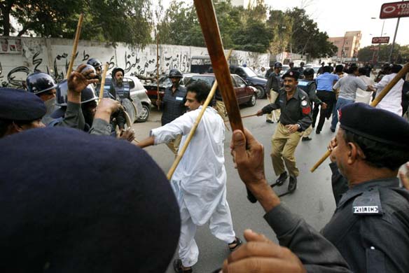 Pakistani riot police beat a journalist with canes 