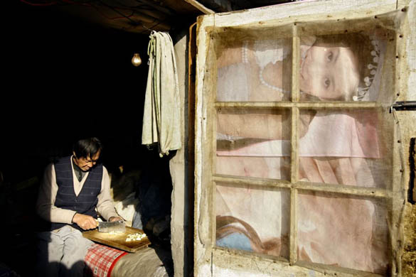 A woman cuts vegetables at her house