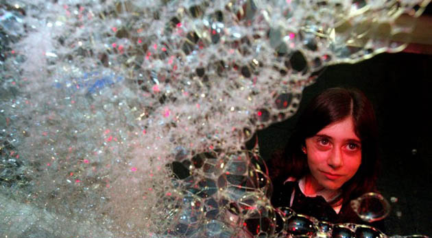 A student watches bubbles move at the Launchpad exhibition at the Science Museum