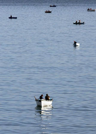 Men fish near Bab El-Ouad coast