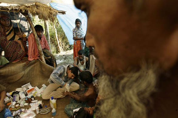 A doctor treats patients at a temporary clinic