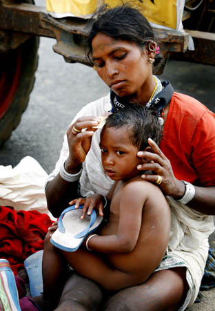 A women combs her son's hair