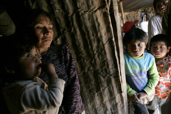 Telma Cardoso, a Toba indigenous woman, holds her son Tiago