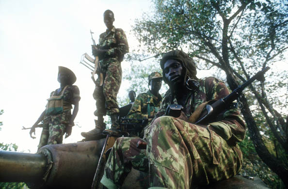 Sudanese People's Liberation Army soldiers stand on a tank