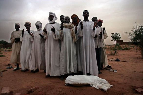 Mourners stand by the body of 1-year-old Ali