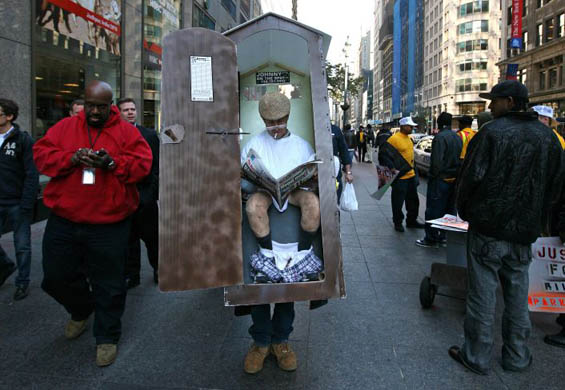 A man dressed as a portable toilet