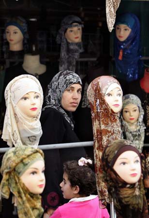 A woman walks past mannequin head
