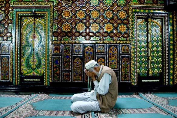 A Kashmiri muslim prays inside the shrine of Shah Hamdan