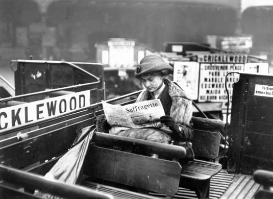 A woman reading a copy of the 'Suffragette' 