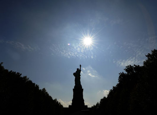  Clouds roll in over the Statue of Liberty