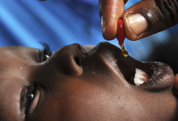A health worker immunises a child at a clinic  in Uganda