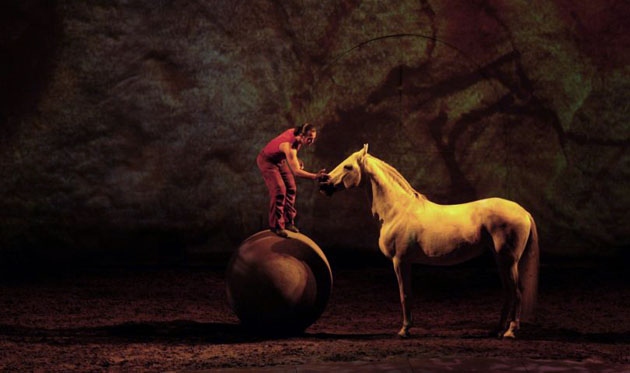 A rider performs with a horse during an equestrian show called  Cavalia