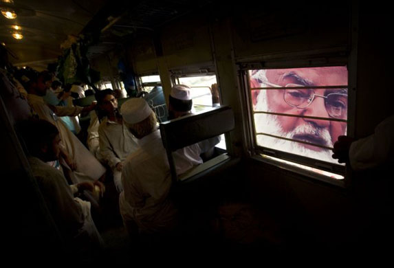 Qazi Hussain Ahmed is seen through a train carriage window