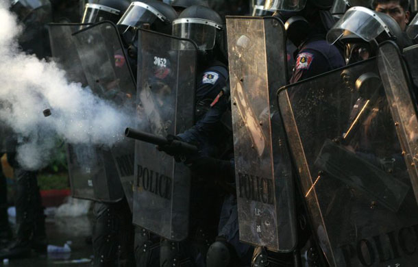 Riot policemen fire tear gas towards anti-government demonstrators    