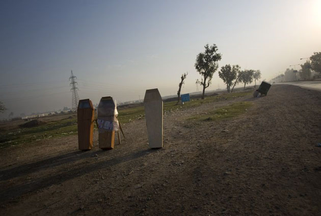 Coffins on sale are seen next to a road on the outskirts of Peshawar, Pakistan  
