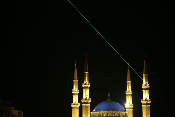 A laser beam points in the direction of the Mecca from a minaret of Mohammed al-Amin mosque  in Beirut