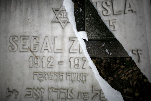 Bucharest, Romania: A broken gravestone is seen after vandalism at a Jewish cemetery 