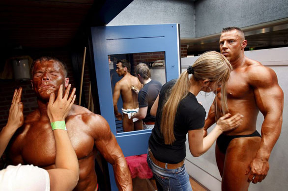 Competitors have fake tan applied before  the Body Building and Fitness Grand Prix  in the Netherlands