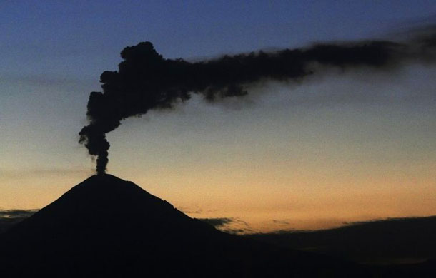 Popocatepetl is seen spewing smoke and ash at sunset  