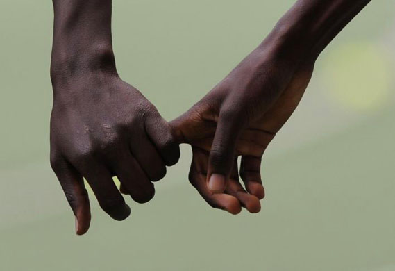 Kenyan runners hold hands at the the IAAF World Athletics Final