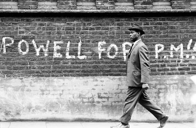 man walking past graffiti 1968