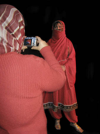 Rahela in traditional Afghani dress being photographed by Shahro
