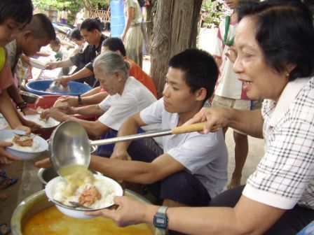 Helpers in a Mae Sot refugee camp in Burma serve children with a meal, provided by the British charity Mary’s Meals