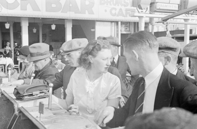 Playing the gambling machines on the Golden Mile