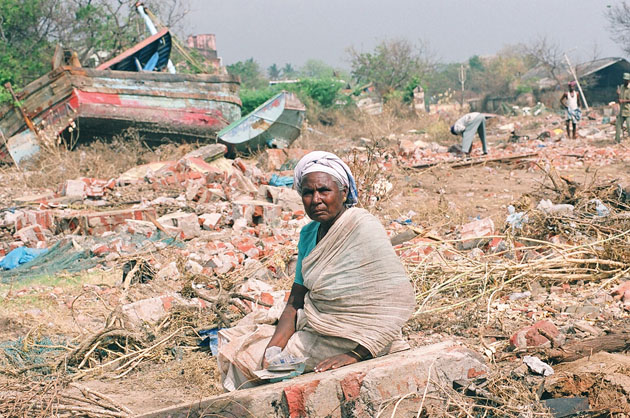 Ariyamala sifts through the ruins of her village