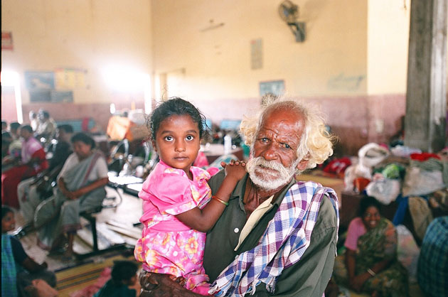 Ramasamy and his granddaughter at a relief camp at Nagapattinam train station, India