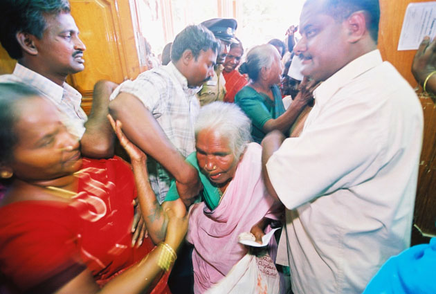 Old woman swept up in chaos of emergency relief