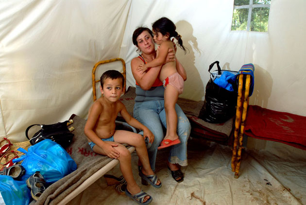 Dato, 6, sits with his mother Lela and sister Nino, 3