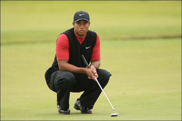 Tiger Woods looks up at the scoreboard