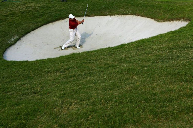 Paul Casey plays a bunker shot