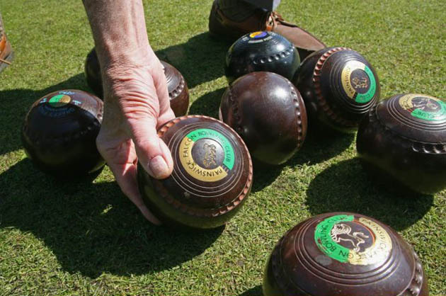 A member of the Falcon Bowling Club picks up a wood 
