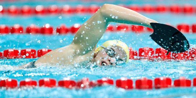 Australia's Lisbeth Trickett swims with hand paddles during a practice session at the National Aquatics Centre