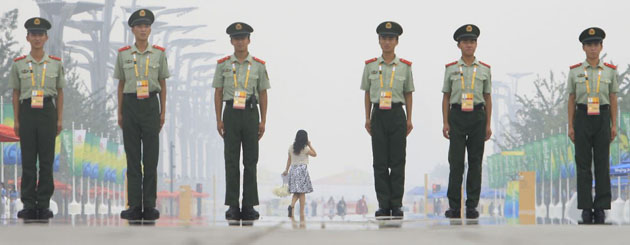 Armed police officers line up on the Olympic Green in Beijing