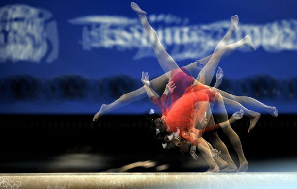 A Japanese gymnast performs on the beam