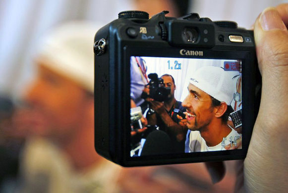 US swimmer Michael Phelps talks to reporters during a press event at the Jintai Art museum