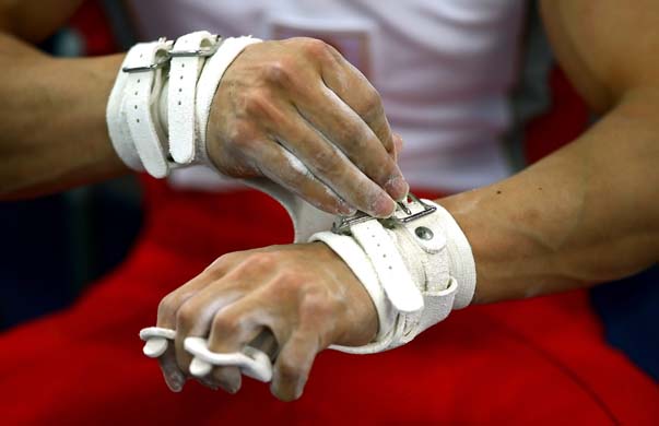 gymnast adjusting his gloves 