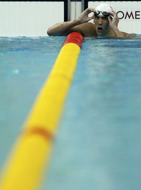 Michael Phelps of the U.S. rests after competing in the heats 