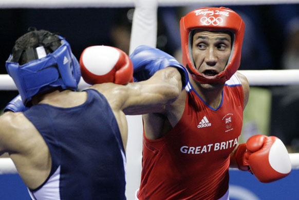 James Degale (R) of Great Britain fights with Mohamed Hikal of Egypt during the middleweight boxing preliminaries in Beijing
