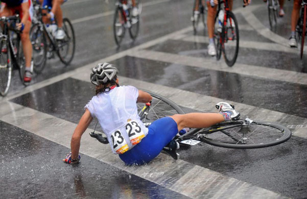 Sharon Laws falls on the wet surface during the women's cycling road race   at the beijing olympics